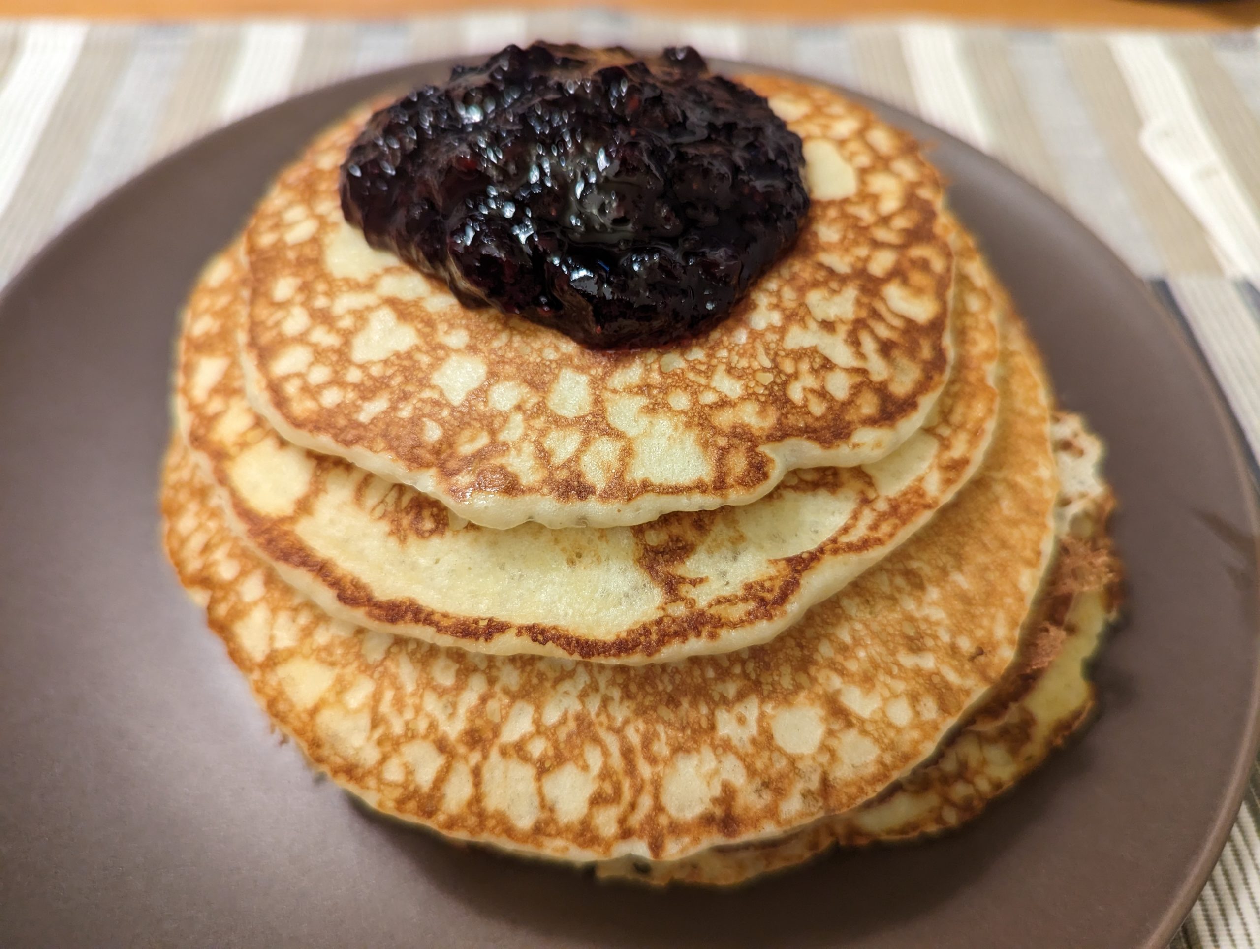A stack of pancakes with jam